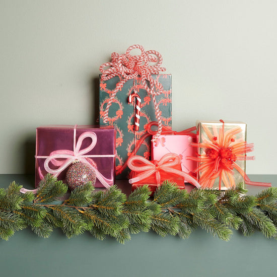 Illustration von eingepackten Geschenken mit unterschiedlichen Bastelband Netzschlauch von Rico Design